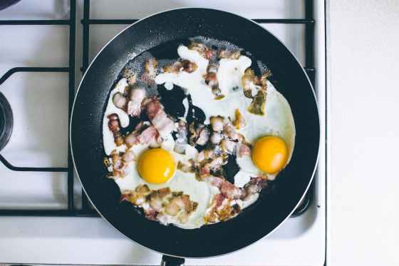 eggs with meat in cooking pan